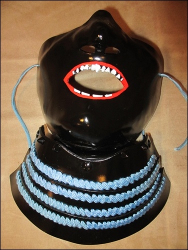 Laquered face- and throat guard including lips and teeth.